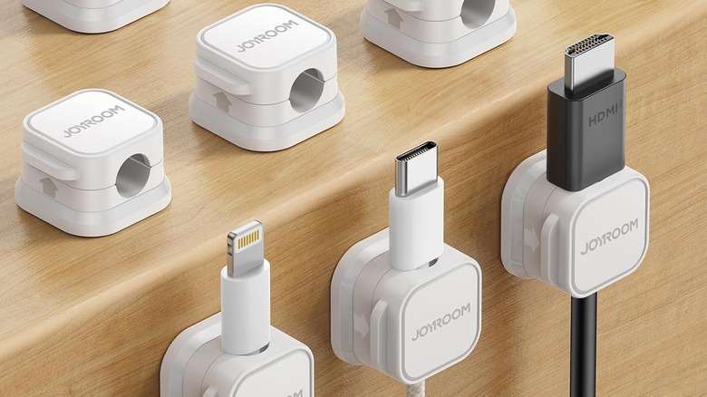 The Joyroom Magnetic Cord Holders holding different kinds of cables.