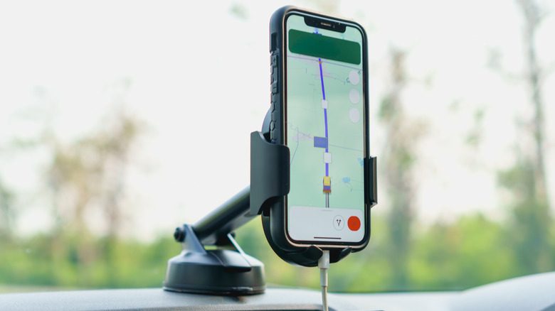 A phone attached to a car phone mount showing a navigation app