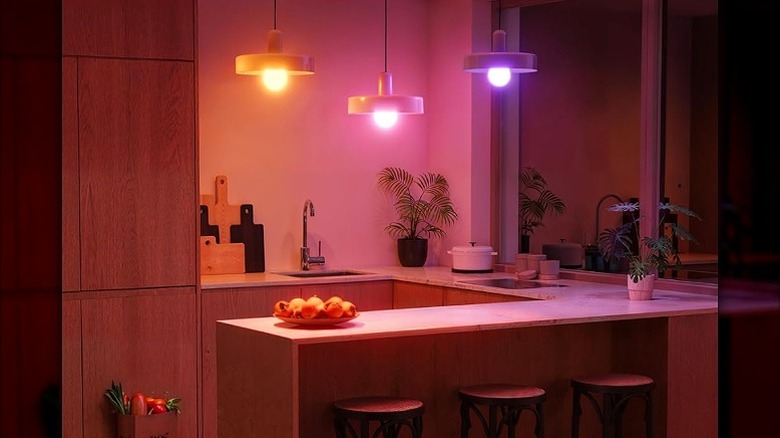 Three RGB hanging lights lighting up a kitchen.