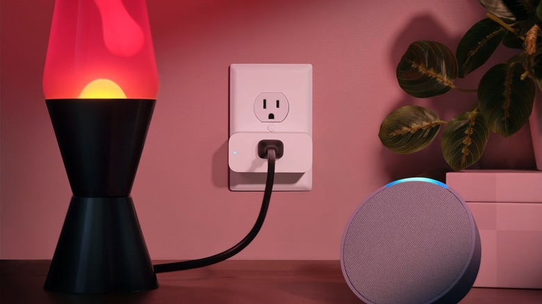 Lamp connected to a smart plug, placed beside an Echo device.