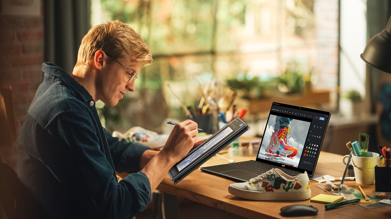 A person working on a Acer Chromebook and a tablet