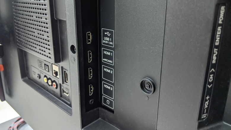 A close up of the various ports on the back of a television.