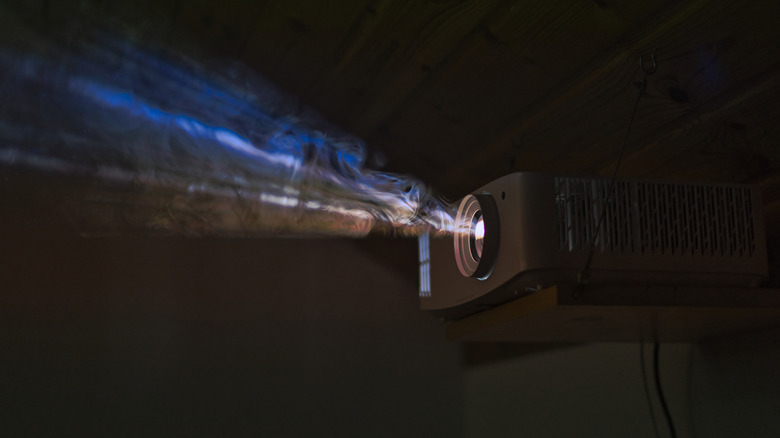 Colorful beam of a projector through smoke