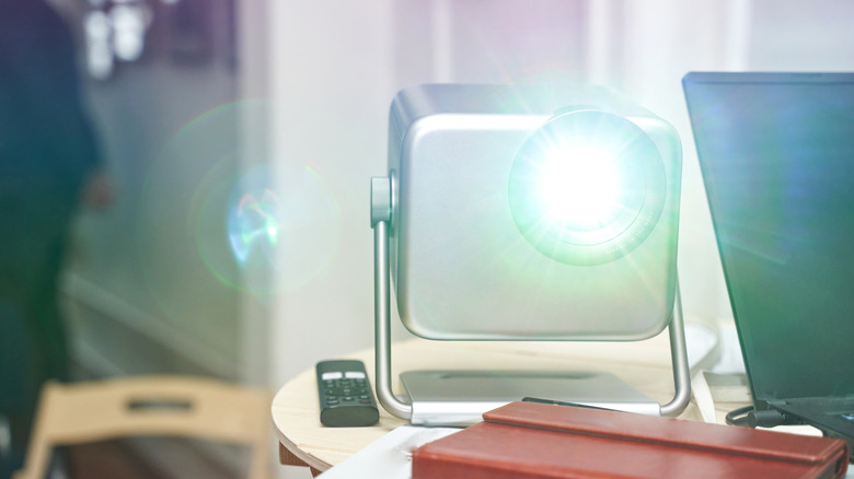 Bright projector illuminating an office environment where it's placed at a skewed angle