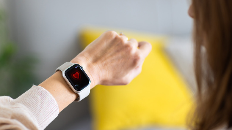 A person checking their heart rate on an Apple Watch.