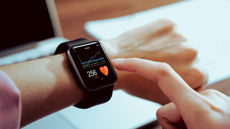 A person looking at health metrics on the smartwatch on their wrist.