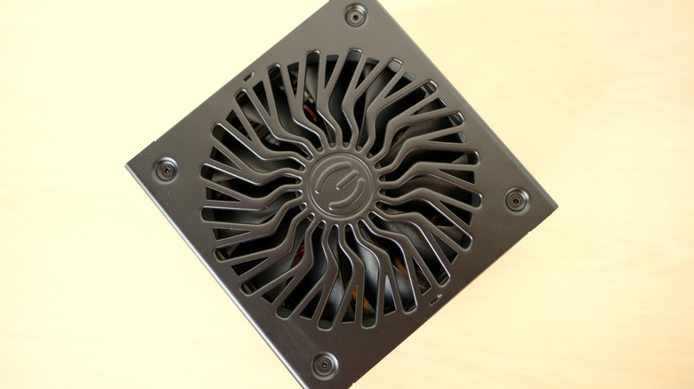 Close-up of the fan grille on an EVGA computer power supply, showing the circular vent design and internal cooling fan.