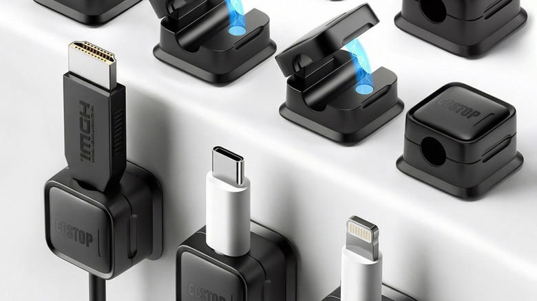 A close up of several magnetic clips holding different computer cables