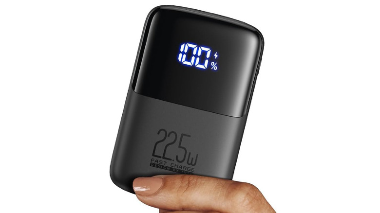 A person holding the INIU Portable Charger on a white background