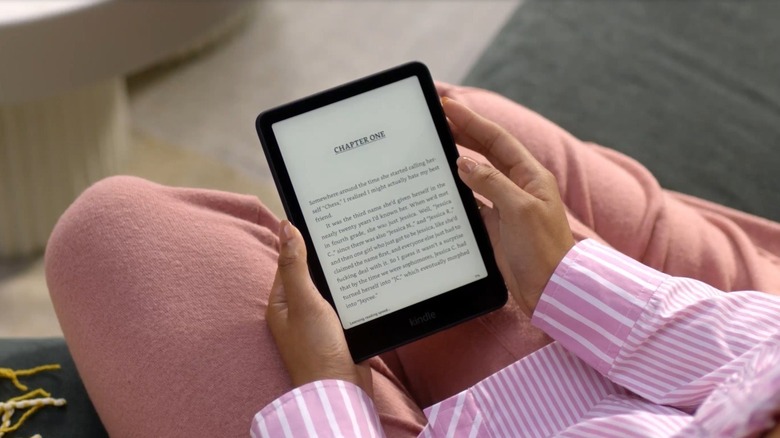 A person reading an e-book on the Amazon Kindle Paperwhite (12th Gen).