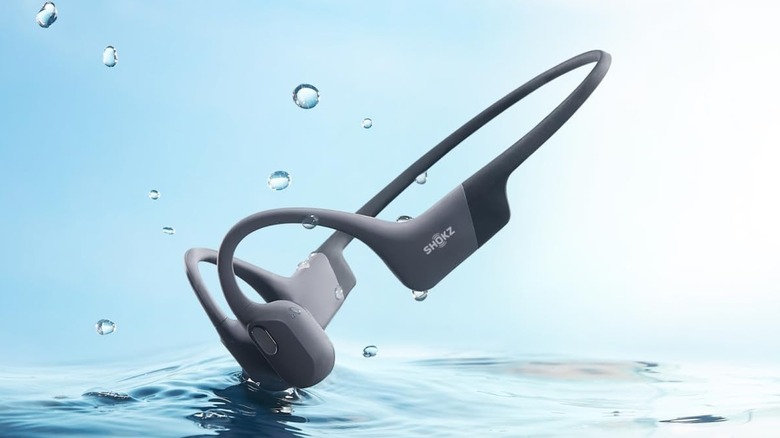 The Shokz OpenSwim Pro bone conduction headphones over water.