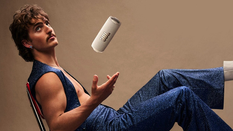 A man flipping a Flip 7 in his hand with his feet up.