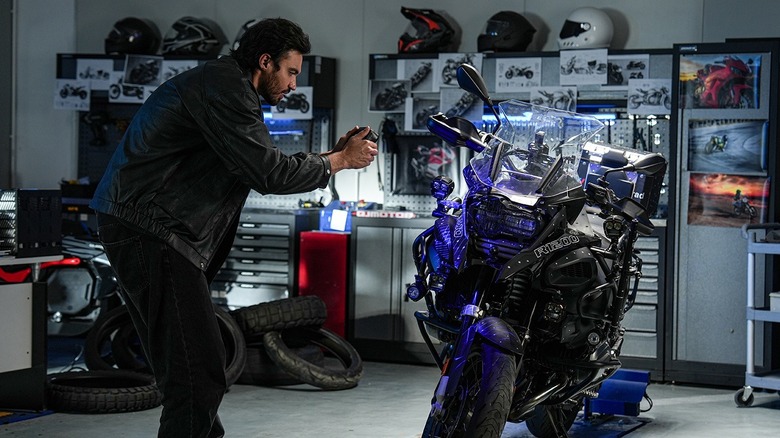 A man scans a motorcycle with a Creality Sermoon P1 3D scanner