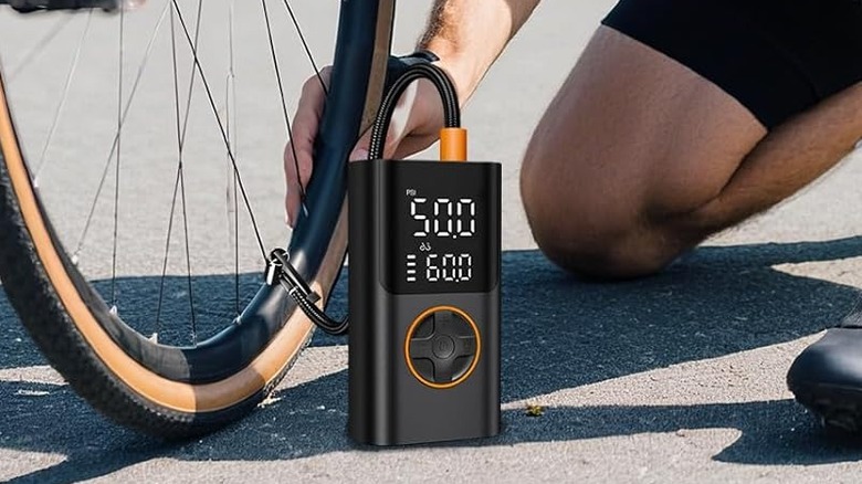 A person inflating a bike tire using the Airsure Portable Tire Inflator.