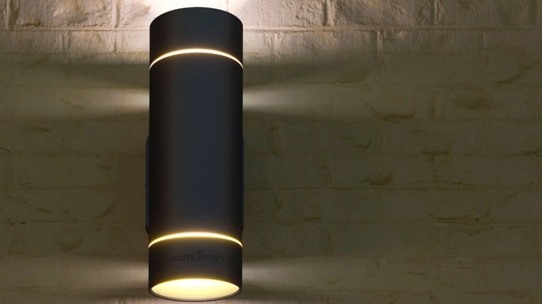 One unit of the Atomi Smart Wi-Fi Rotundus Outdoor Wall Sconces, installed on a stone wall.