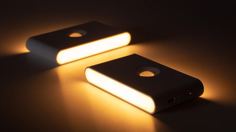Two small lights turned on in a dark room