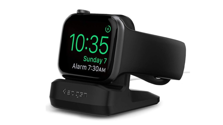 An Apple Watch charging on the Spigen Apple Watch Stand S350, on a white background.