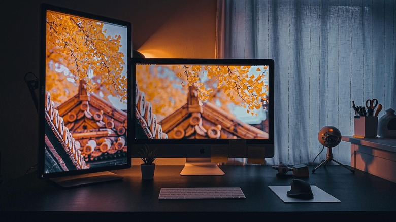A dual monitor setup with a vertical screen