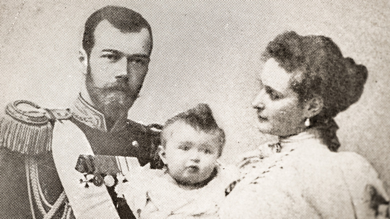 Tsar Nicholas II with wife and child in an old photograph.
