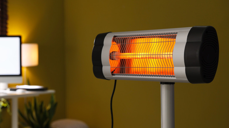Portable infrared space heater with glowing heating element.