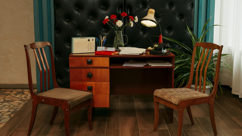 Classic desk set up with old devices, vintage gadgets, and rotary telephone