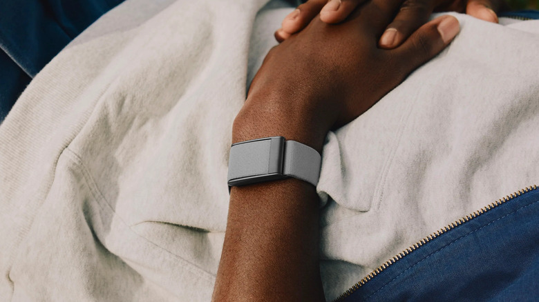 A person wearing the Whoop 5.0 fitness wearable