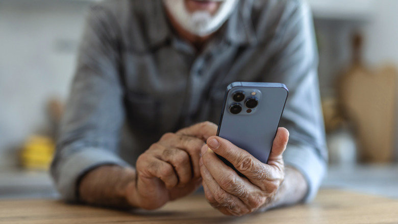 An elderly man using a smartphone