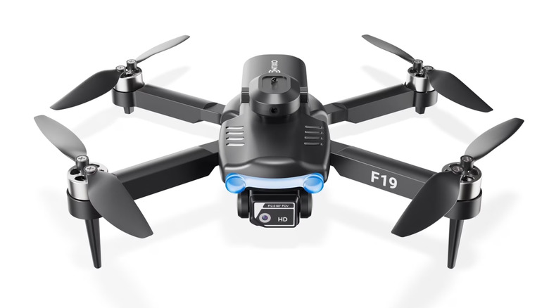 Flying Mini Drone with all propellers out on a white background