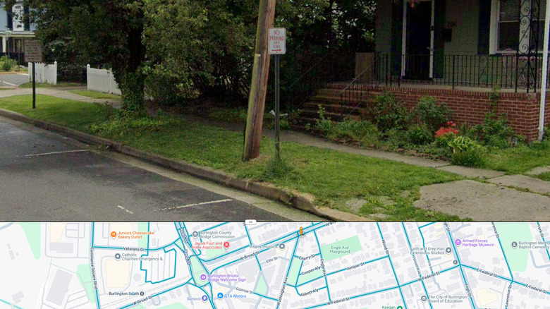 A screenshot of the Google Maps street view, showing a street with a "no parking" sign.