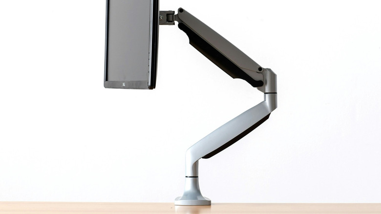 The Herman Miller Jarvis single monitor arm (with monitor) attached to a desk.