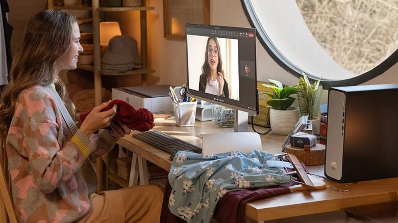 Woman conversing in an online call while sitting at her desk.