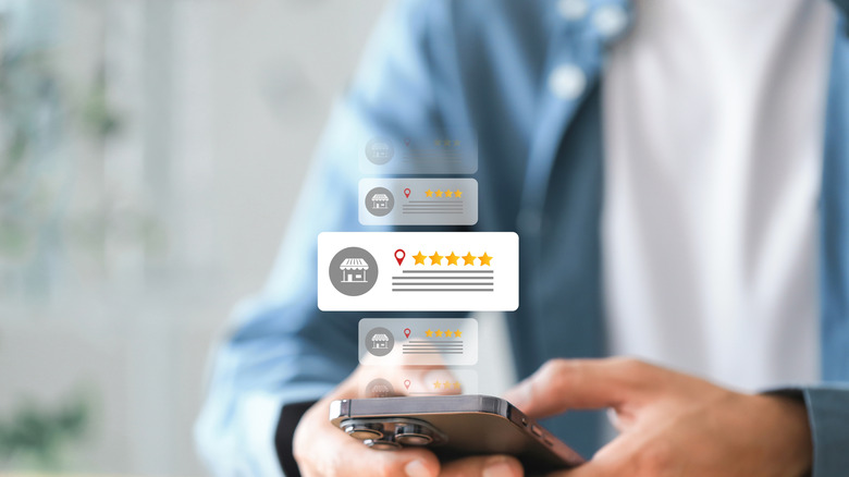 Holographic images of five star rating boxes above a smartphone.