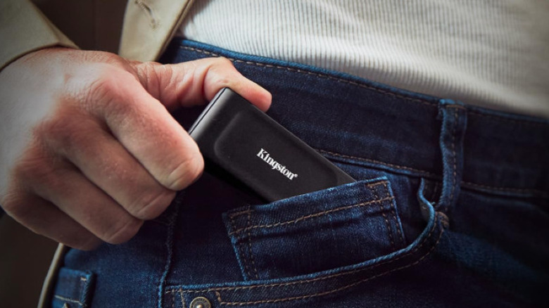A Kingston SSD is shown half in a jeans pocket