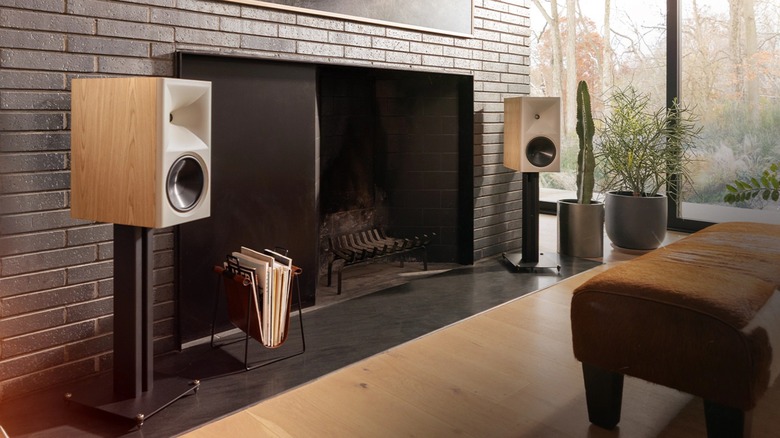 Klipsch The Nines II bookshelf speakers placed on top of stands in a modern living room setup.