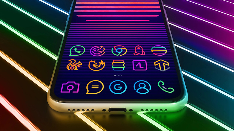 A phone displaying the designs of the LineX icon pack, placed on a surface bathed in neon light