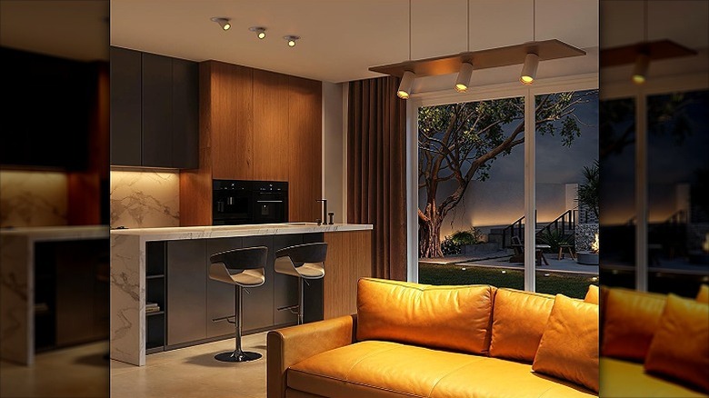 A warmly lit modern lounge with see-through glass doors.