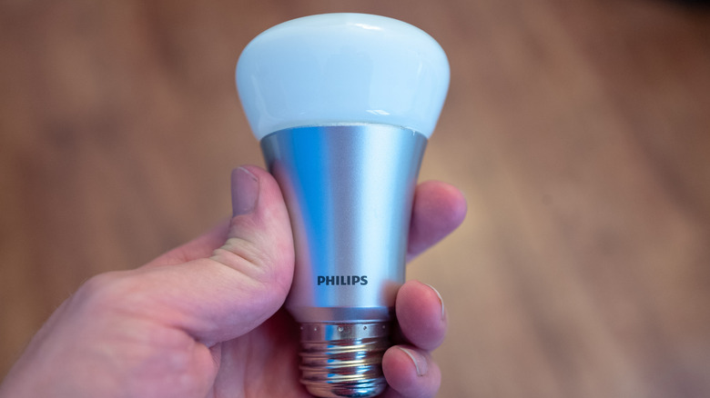 hand holding a philips hue bulb