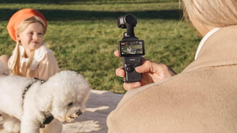 A person using the DJI Osmo Pocket 3 vlogging camera to record a video.