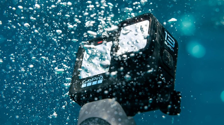 The GoPro Hero 13 Black action camera submerged in water.