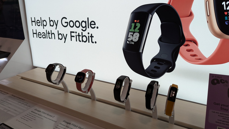 Fitbit fitness trackers and smartwatches on display.