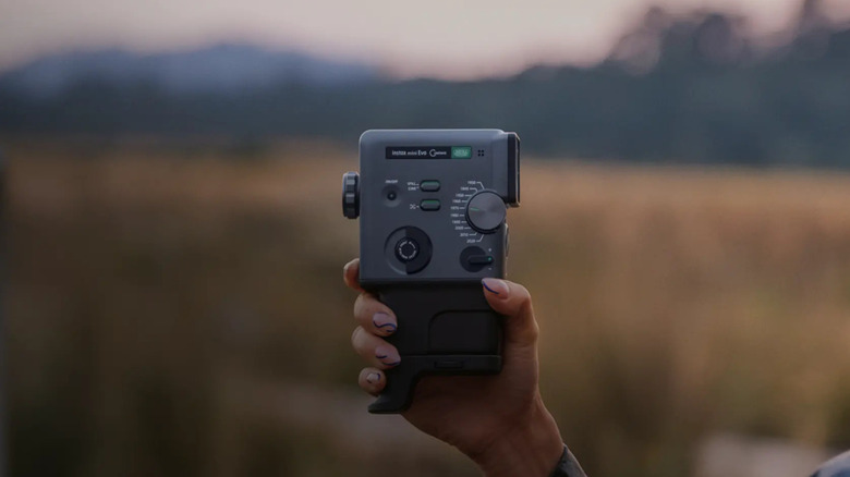 A person shooting with the Fujifilm Instax Mini Evo Cinema