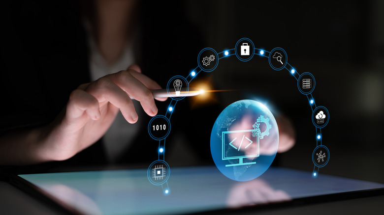 A man walking through an airport terminal, with a suitcase and smartphone.