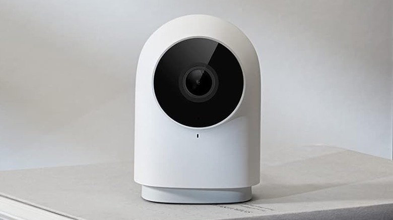 The Aqara G2H Pro on top of some books.