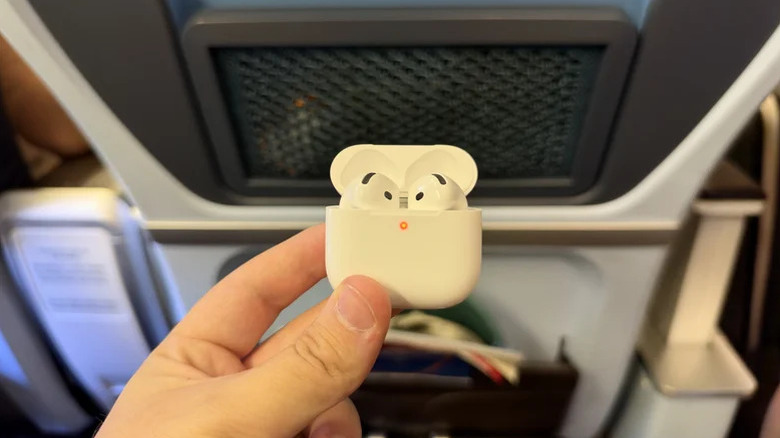 A hand holds an open AirPods 5 case.