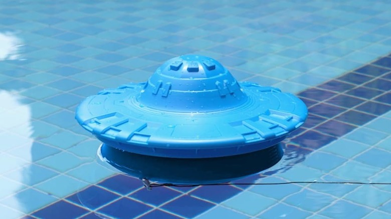The Hovara PS01 pool alarm floating on the water of a swimming pool.