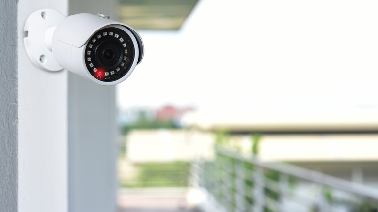 A security camera installed on a wall outdoors.