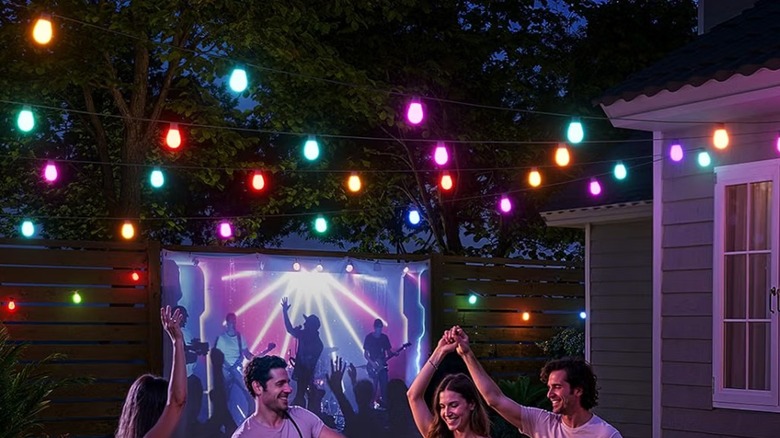 The Govee S14 outdoor smart lights illuminating a backyard party.