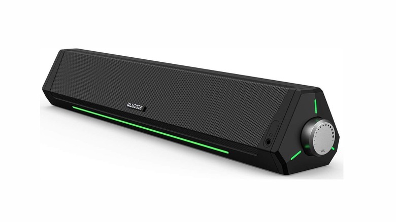 A long black soundbar with "BLUEDEE" labeled on it. There's a knob on the side and green LED light stripes on the bottom and side.