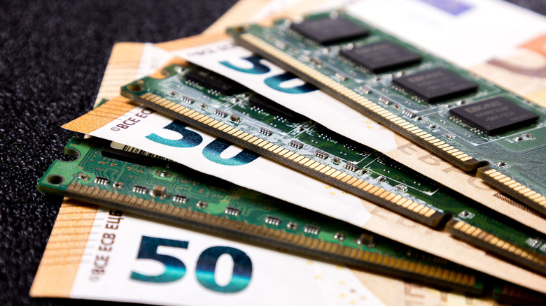 RAM sticks interleaved with banknotes.