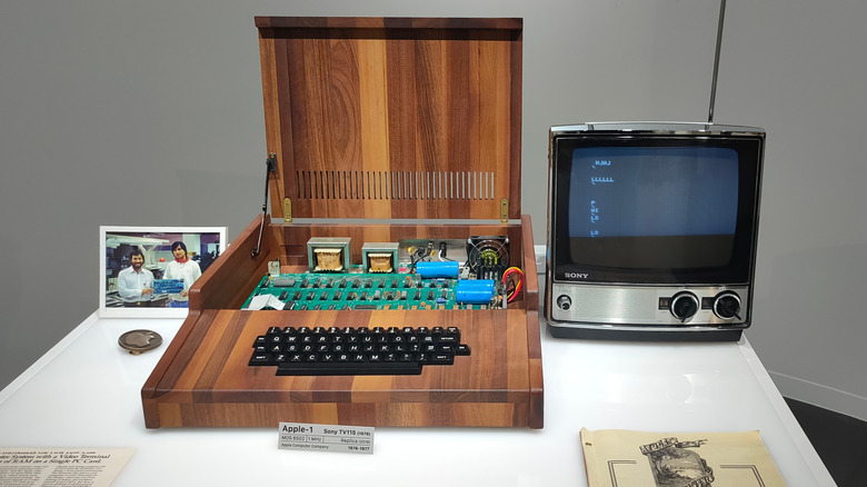 A replica of a vintage Apple 1 computer next to an old Sony monitor
